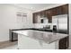 Modern kitchen with granite countertops and dark cabinets at 37501 Williamette Way, Zephyrhills, FL 33540