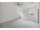 Spacious bedroom with carpeted floors and two large windows at 37508 Williamette Way, Zephyrhills, FL 33540