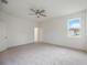 Bright and airy bedroom with ceiling fan and large window at 37508 Williamette Way, Zephyrhills, FL 33540