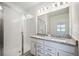 Modern bathroom with double vanity, granite countertop, and walk-in shower at 37513 Williamette Way, Zephyrhills, FL 33540