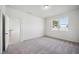 Bright bedroom with gray carpet and large window at 37513 Williamette Way, Zephyrhills, FL 33540