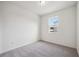 Bright bedroom featuring grey carpet and a window at 37513 Williamette Way, Zephyrhills, FL 33540