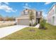 Two-story house with gray siding, brown roof, and a two-car garage at 37736 Yukon Dr, Zephyrhills, FL 33540