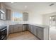 Modern kitchen with gray cabinets, granite countertops, and stainless steel appliances at 37736 Yukon Dr, Zephyrhills, FL 33540