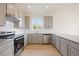 Modern kitchen with gray cabinets, granite countertops, and stainless steel appliances at 37736 Yukon Dr, Zephyrhills, FL 33540