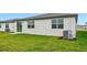 New construction home featuring a large backyard and AC unit at 7760 Gilchrist Springs Dr, Parrish, FL 34219
