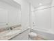 Clean bathroom with granite vanity and a bathtub shower combo at 7760 Gilchrist Springs Dr, Parrish, FL 34219