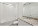 Clean bathroom with granite countertop and a bathtub shower combo at 7760 Gilchrist Springs Dr, Parrish, FL 34219