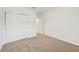 Spacious bedroom featuring carpet flooring and an adjacent bathroom at 7760 Gilchrist Springs Dr, Parrish, FL 34219
