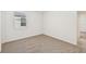 Bright bedroom with neutral walls and carpet, window with blinds at 7760 Gilchrist Springs Dr, Parrish, FL 34219