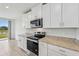 Modern kitchen featuring granite countertops and stainless steel appliances at 7760 Gilchrist Springs Dr, Parrish, FL 34219