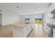 Modern kitchen with island, white cabinets, granite counters, and view to pond at 7760 Gilchrist Springs Dr, Parrish, FL 34219