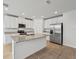 Modern kitchen with white cabinets, granite countertops, and stainless steel appliances at 7760 Gilchrist Springs Dr, Parrish, FL 34219