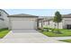 View of the house from the street, showing the front yard and driveway at 444 Lazy Shore Dr, Nokomis, FL 34275