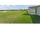 Large grassy backyard with a patio, providing ample outdoor space at 184 Lazy Shore Dr, Nokomis, FL 34275