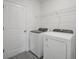 Convenient laundry room with washer, dryer, and overhead shelving at 184 Lazy Shore Dr, Nokomis, FL 34275