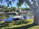 Relaxing backyard with a floating dock and hammock at 14914 Capri Ln, Hudson, FL 34667