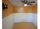 Empty bedroom with orange walls and white wainscoting at 14914 Capri Ln, Hudson, FL 34667