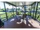 Screened porch with wooden deck and seating at 14914 Capri Ln, Hudson, FL 34667