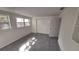 Well-lit bedroom featuring grey flooring and ample closet space at 4652 Alma St, New Port Richey, FL 34652