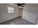 Bright bedroom with grey flooring, a closet, and a ceiling fan at 4652 Alma St, New Port Richey, FL 34652