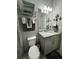 Modern bathroom with gray vanity and walk-in shower at 8394 Olive Brook Dr, Wesley Chapel, FL 33545