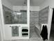 Spacious shower with gray tile and built-in seat at 8394 Olive Brook Dr, Wesley Chapel, FL 33545