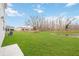Spacious backyard with a pond view and grassy area at 37545 Mackenzie Dr, Zephyrhills, FL 33540