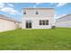 Large backyard with a grassy area and a privacy fence at 37545 Mackenzie Dr, Zephyrhills, FL 33540