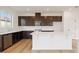 Kitchen features dark cabinets, white countertops, and stainless steel appliances at 37545 Mackenzie Dr, Zephyrhills, FL 33540