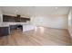 Open concept kitchen with dark cabinetry, stainless steel appliances, and light flooring at 37545 Mackenzie Dr, Zephyrhills, FL 33540