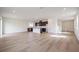 Open concept kitchen with island, dark cabinetry, and hardwood floors at 37545 Mackenzie Dr, Zephyrhills, FL 33540