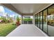 Covered patio featuring sleek sliding glass doors that open to an outdoor oasis of greenery and open sky at 11146 Rustic Timber Loop, San Antonio, FL 33576