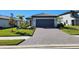 Single-story home with gray paver driveway and landscaped lawn at 6052 Baywood Ct, Lakewood Ranch, FL 34211