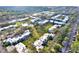 Aerial view shows well-maintained condo community with mature trees, green space, ample parking, and communal pool at 2814 Somerset Park Dr # 202, Tampa, FL 33613