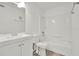 A bright bathroom features a modern vanity, toilet, and bathtub with shower at 2814 Somerset Park Dr # 202, Tampa, FL 33613