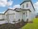 Charming two-story home with a two-car garage, light blue door, and well-maintained landscaping at 14045 Crutchfield Ct, Parrish, FL 34219