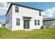 Rear view of house with sliding glass door and green lawn at 14045 Crutchfield Ct, Parrish, FL 34219