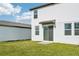 Rear view of house showing sliding glass door and yard at 14045 Crutchfield Ct, Parrish, FL 34219