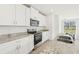 Bright kitchen with white cabinets, granite counters, and stainless steel appliances at 14045 Crutchfield Ct, Parrish, FL 34219