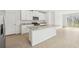 Modern kitchen with white cabinets, granite countertops, and a large island at 14045 Crutchfield Ct, Parrish, FL 34219