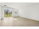 Bright living room with wood-look tile flooring and sliding glass doors to backyard at 14045 Crutchfield Ct, Parrish, FL 34219