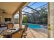 Screened-in pool and spa with patio furniture at 11909 Mandevilla Ct, Tampa, FL 33626