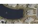 Property's aerial view showing its location on a lake at 906 Bluewater Dr, Sun City Center, FL 33573