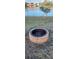 Landscaped backyard with a brick fire pit at 906 Bluewater Dr, Sun City Center, FL 33573