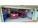 Garage with golf cart, SUV, and storage shelves at 906 Bluewater Dr, Sun City Center, FL 33573