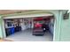 Garage with golf cart, motorcycle, and storage shelves at 906 Bluewater Dr, Sun City Center, FL 33573