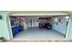 Garage with golf cart, motorcycle, and storage shelves at 906 Bluewater Dr, Sun City Center, FL 33573