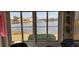 Spacious sunroom with serene lake view from large windows at 906 Bluewater Dr, Sun City Center, FL 33573