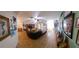 Spacious living room featuring a large leather couch and decorative wall art at 906 Bluewater Dr, Sun City Center, FL 33573
